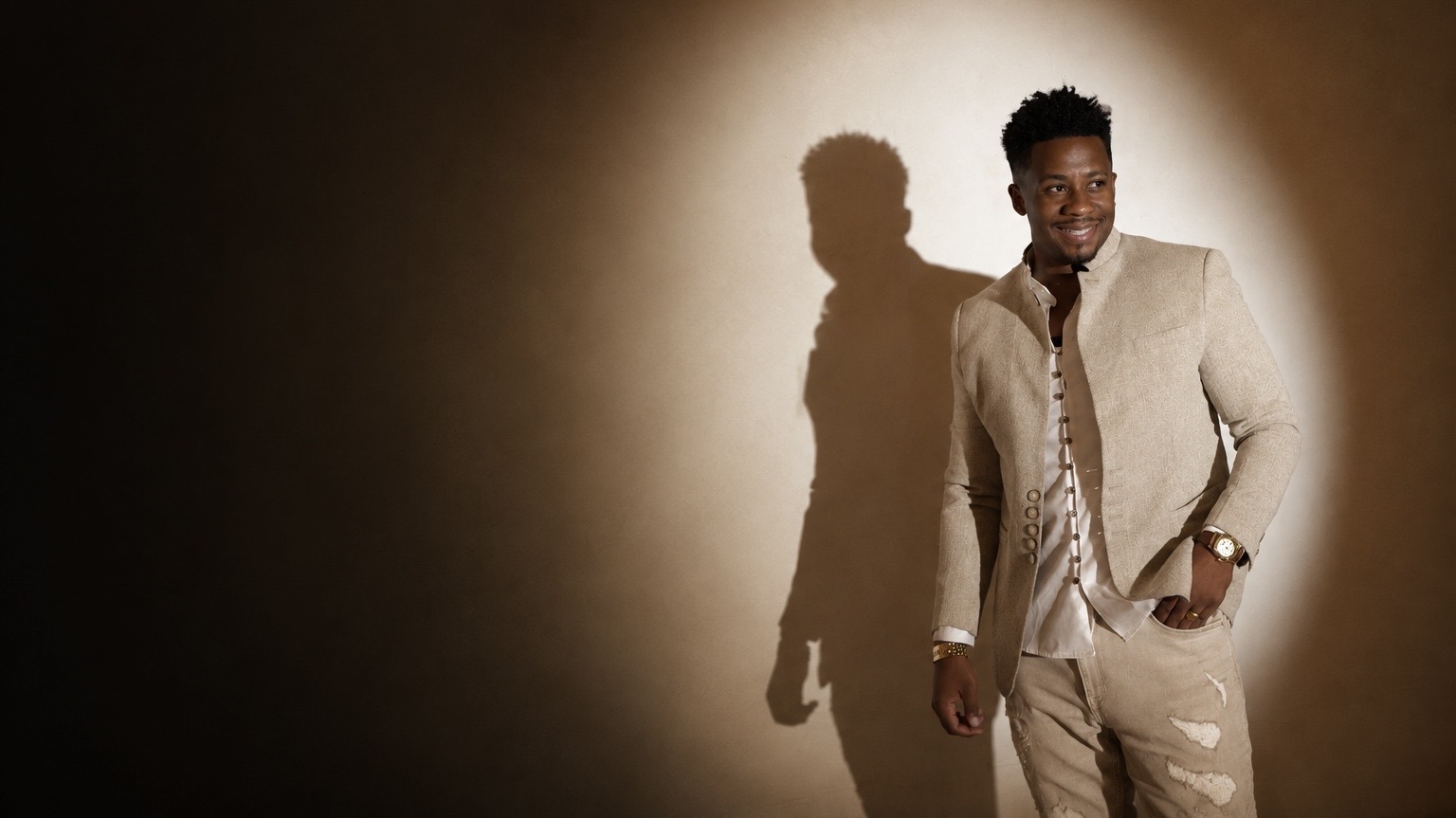Flytimeless — artist in tan suit, studio light